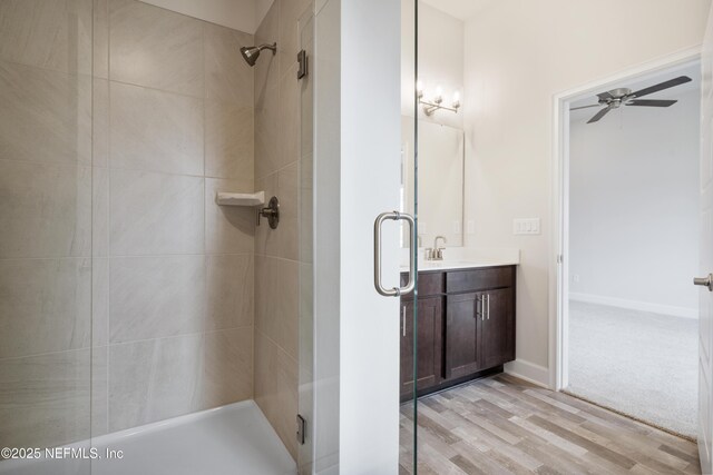 3145 Forest View Ln, Green Cove Springs, FL 32043 - full bath with a stall shower, a ceiling fan, vanity, and wood finished floors