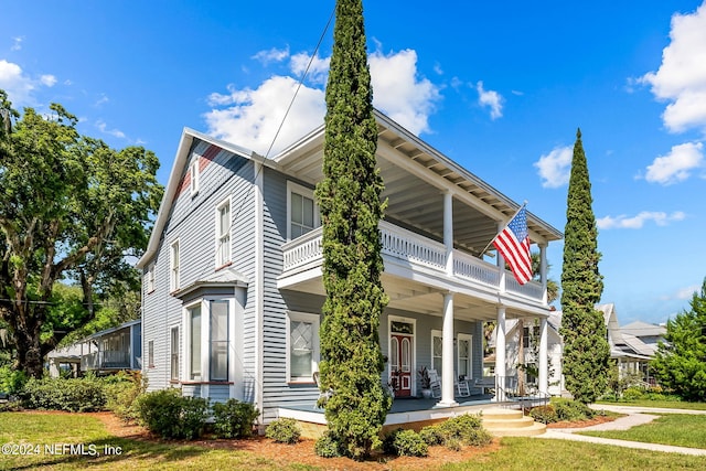 view of front of house featuring a porch and a front yard