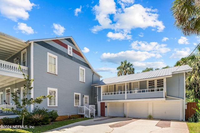 view of front of house with a garage and a balcony