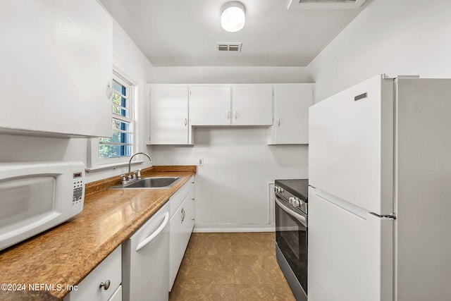 kitchen with white cabinetry, stainless steel appliances, and sink