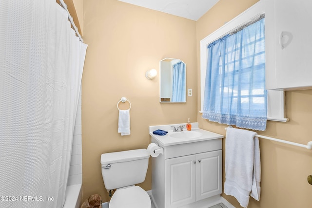 full bathroom featuring toilet, shower / bath combo, and vanity