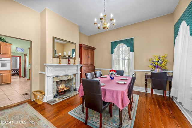 dining room with wood-type flooring and an inviting chandelier