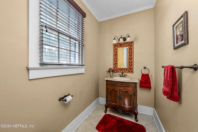 bathroom with vanity, ornamental molding, and tile patterned flooring