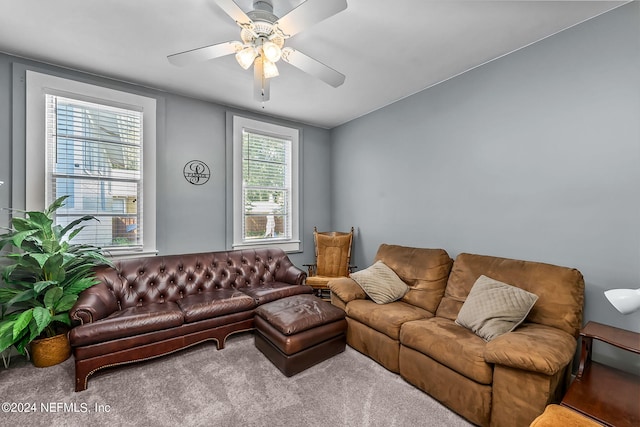 carpeted living room featuring ceiling fan