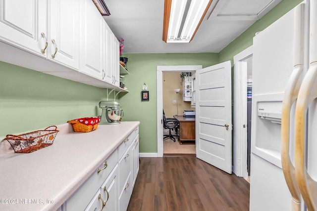 kitchen with white cabinets, white refrigerator with ice dispenser, and dark hardwood / wood-style flooring