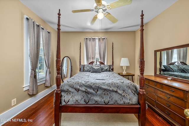 bedroom featuring dark wood-type flooring, ceiling fan, and multiple windows