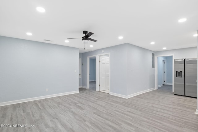 unfurnished living room with light wood-type flooring and ceiling fan