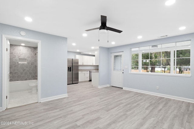 unfurnished living room with light wood-type flooring and ceiling fan