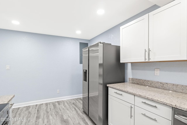 kitchen with white cabinetry, light hardwood / wood-style flooring, and stainless steel appliances