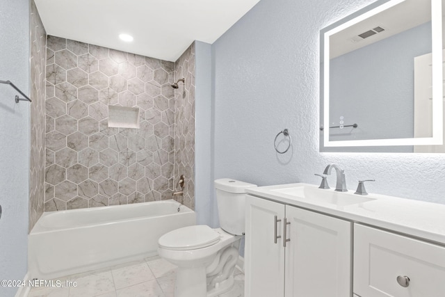 full bathroom with tiled shower / bath, vanity, toilet, and tile patterned flooring