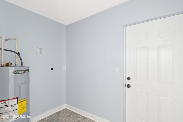 clothes washing area with tile patterned floors, electric water heater, and electric dryer hookup