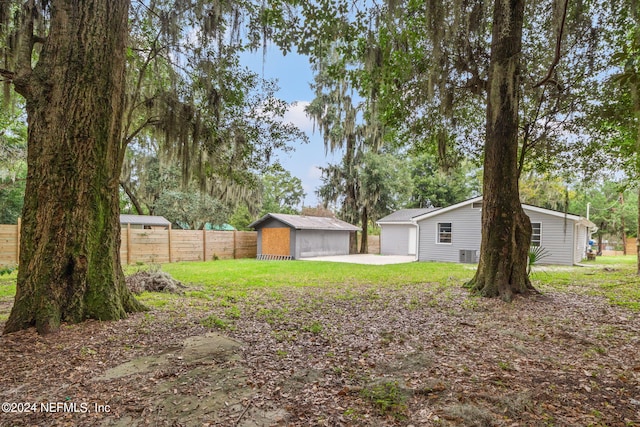 view of yard with central AC and a storage unit