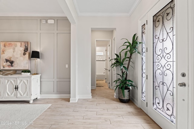 foyer featuring ornamental molding