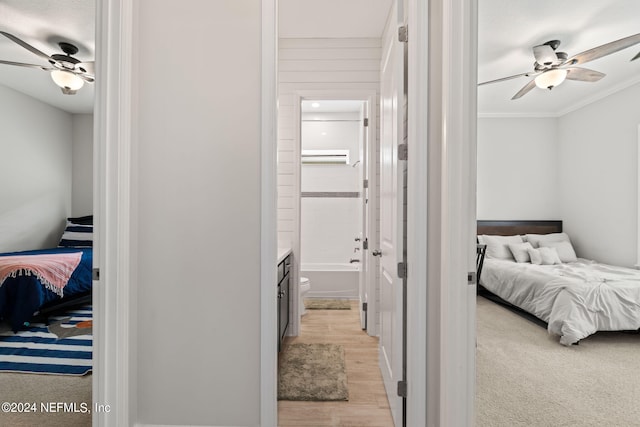 bedroom with ceiling fan, ornamental molding, and light hardwood / wood-style flooring