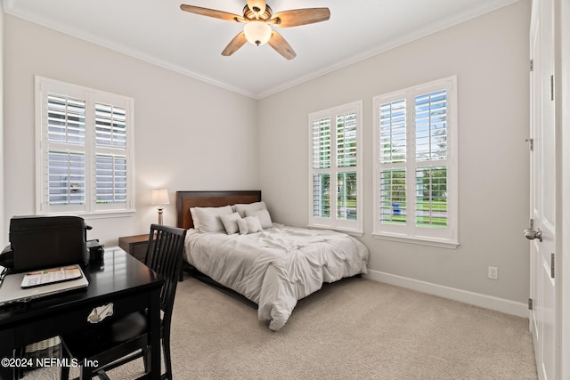 carpeted bedroom with ceiling fan and ornamental molding