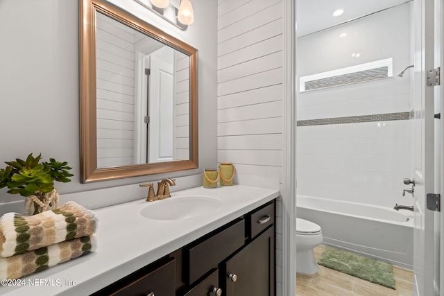 full bathroom featuring tub / shower combination, vanity, and toilet