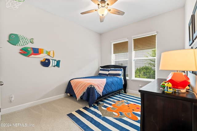 carpeted bedroom featuring baseboards and ceiling fan