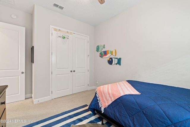 carpeted bedroom with a closet and ceiling fan