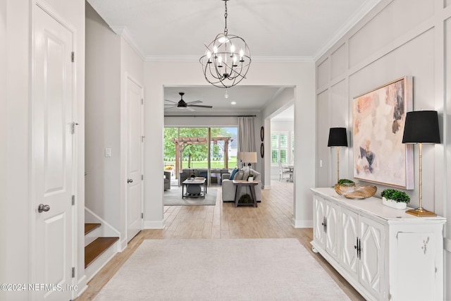 hallway featuring a chandelier, light hardwood / wood-style floors, and crown molding