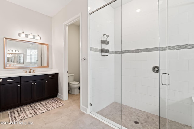 bathroom featuring walk in shower, tile patterned floors, vanity, and toilet