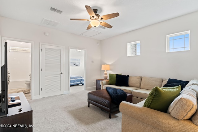 living room with ceiling fan and light carpet