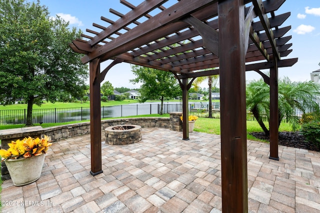 view of patio / terrace featuring a fire pit, a pergola, and a water view