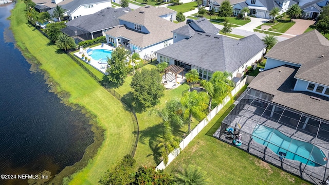 birds eye view of property with a water view