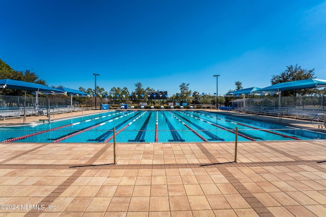 community pool featuring a patio and fence