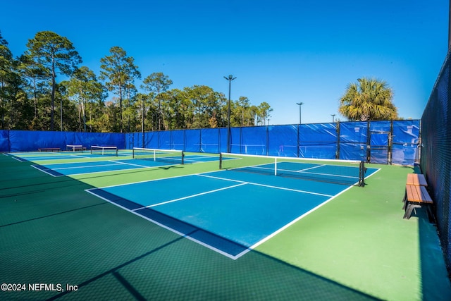 view of tennis court featuring basketball court