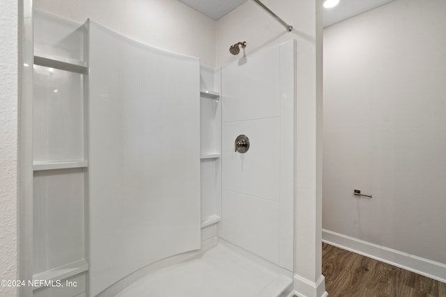 bathroom featuring a shower and hardwood / wood-style floors