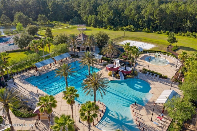 view of swimming pool with a water slide and a patio area