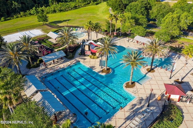 view of swimming pool featuring a yard and a patio area