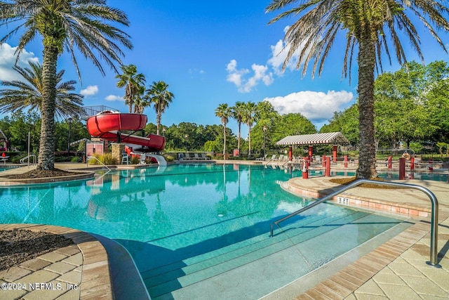 view of pool with a water slide