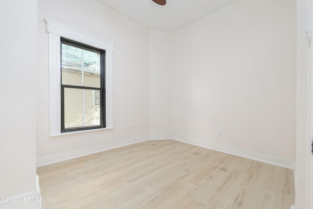 empty room with ceiling fan and light hardwood / wood-style floors