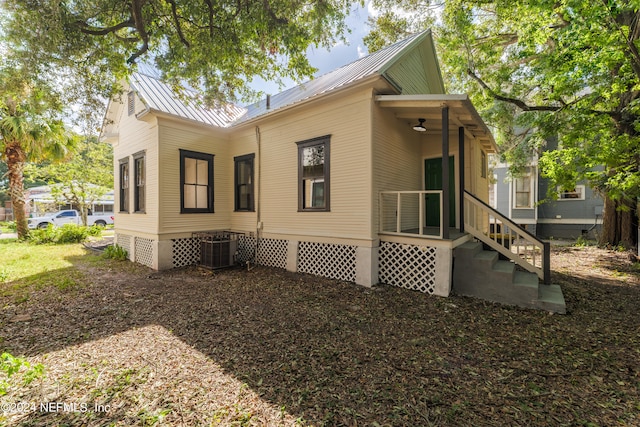 rear view of property featuring central air condition unit