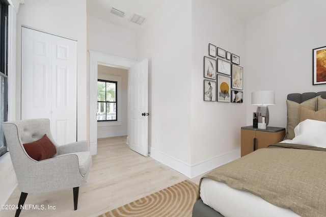 bedroom featuring a closet and light wood-type flooring