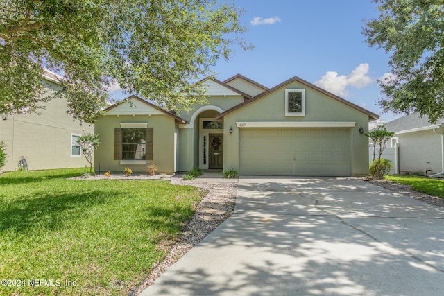 view of front of home with a front lawn and a garage