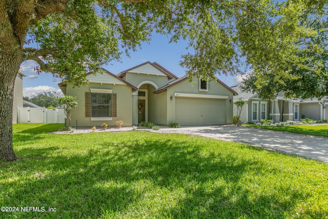 view of front of house with a front lawn and a garage