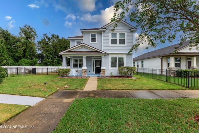 view of front of home with covered porch and a front yard