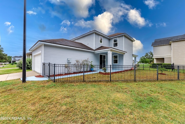 back of property with a garage and a yard