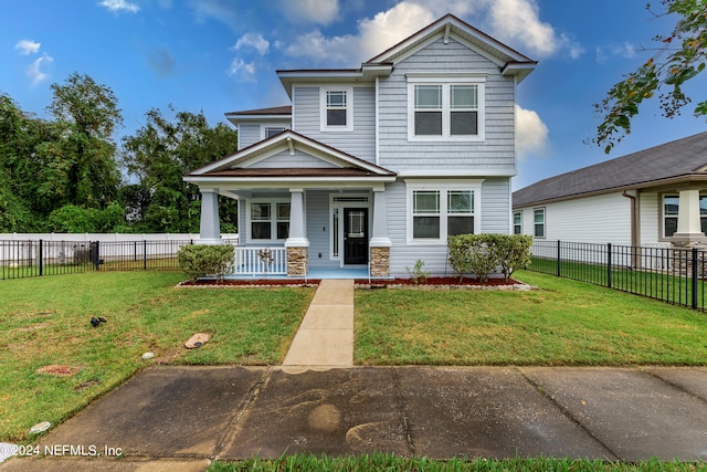 view of front of property with a porch and a front lawn