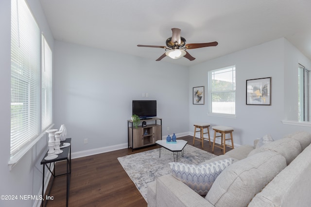 living room featuring ceiling fan and dark wood-type flooring