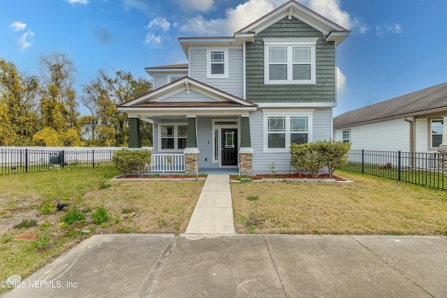 view of front of house with a front yard, covered porch, and fence