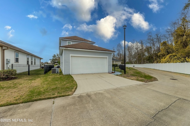 view of home's exterior featuring a garage, a lawn, and fence