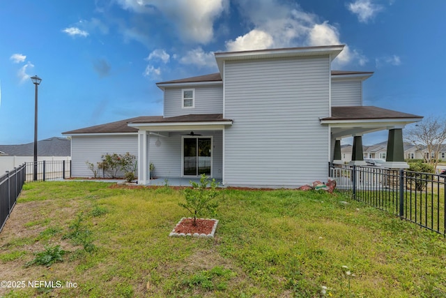 rear view of property featuring a fenced backyard, a lawn, and a patio