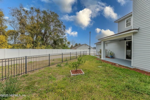 view of yard featuring a ceiling fan, a patio area, and a fenced backyard