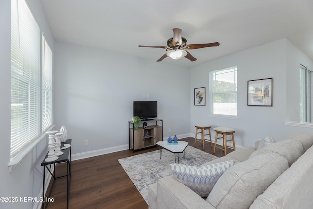 living area featuring ceiling fan, baseboards, and dark wood finished floors