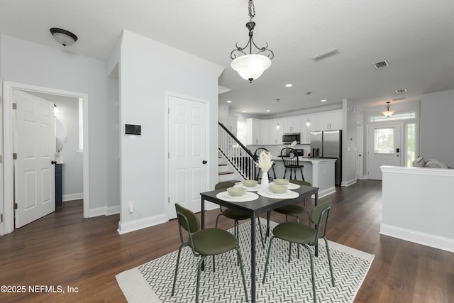 dining area featuring recessed lighting, dark wood-type flooring, visible vents, baseboards, and stairs