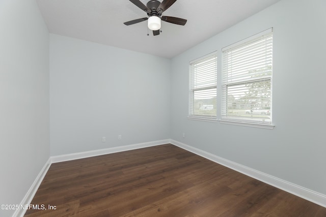 unfurnished room featuring a ceiling fan, baseboards, and dark wood-type flooring