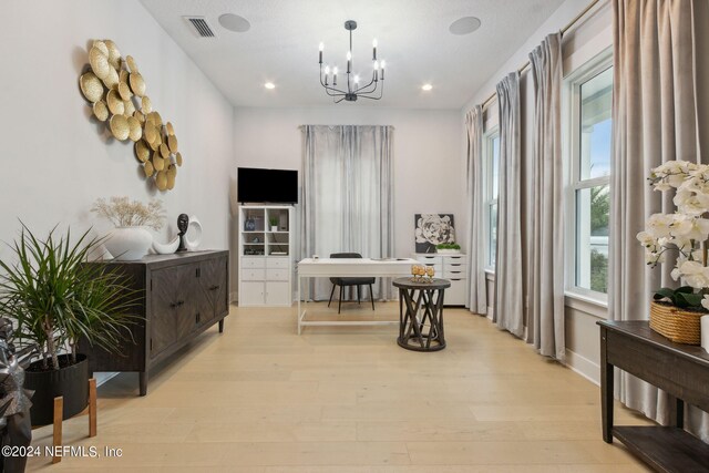 dining room featuring light hardwood / wood-style floors and a notable chandelier